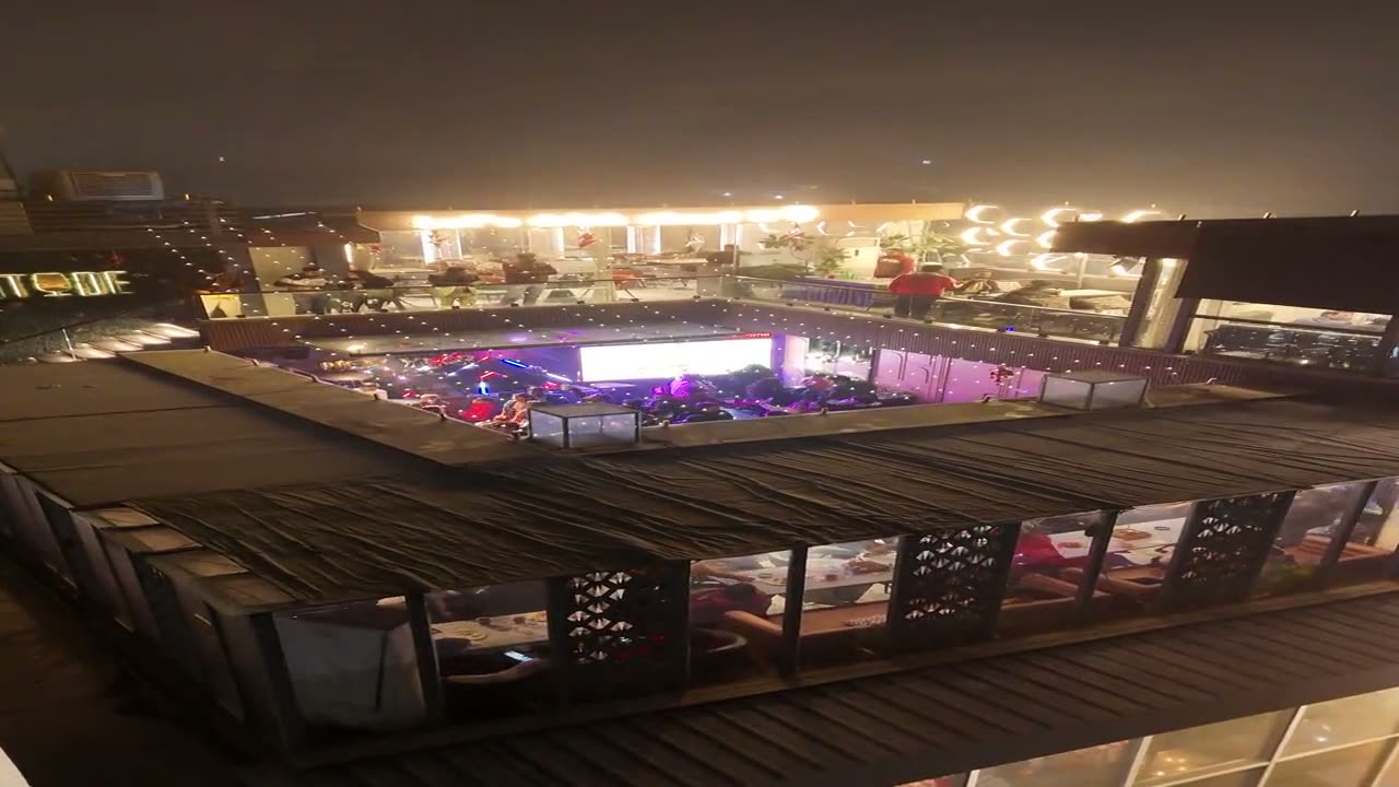 The Altitude rooftop at night, seen from across the terrace